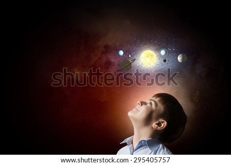 Cute boy of school age exploring space system