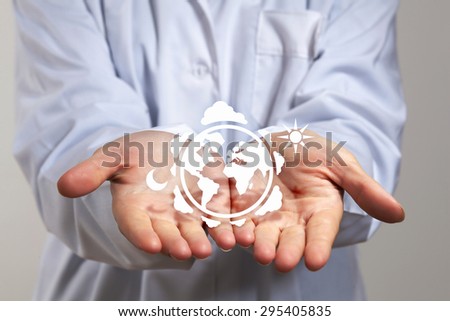 Close up of hands with white Earth planet figure