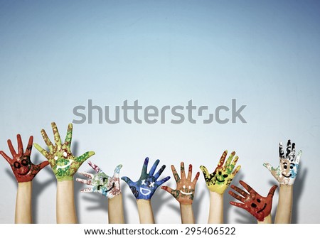 Image of human hands in colorful paint with smiles