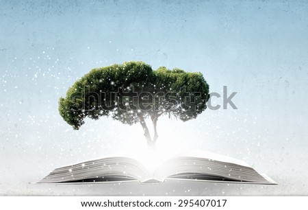 Conceptual image with green tree growing from book