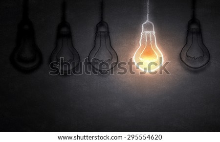 Illuminating hanging light bulb on dark background