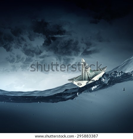 Paper ship floating on water on stormy waves