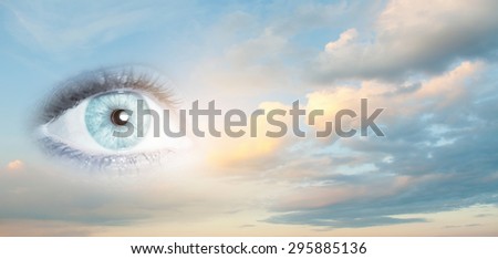 Female clear eye on blue sky background