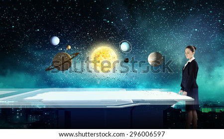 Young businesswoman and planets of space spinning around