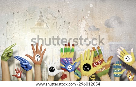Image of human hands in colorful paint with smiles