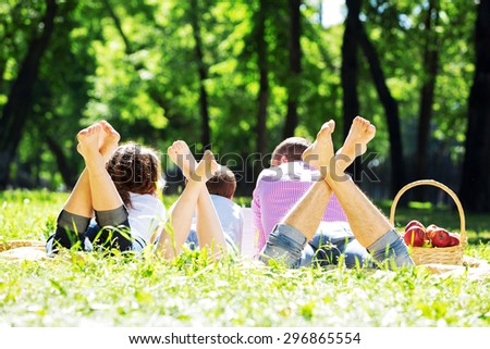 Happy family having weekend in summer park