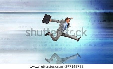 Young businessman in suit running at full pelt