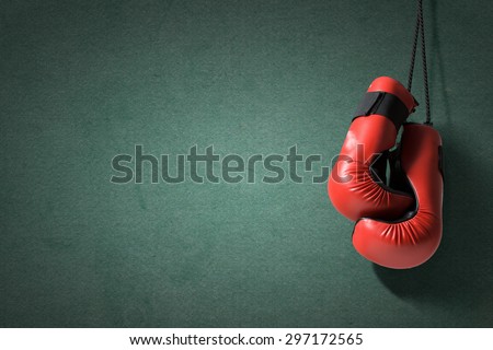 Boxing gloves hanging on nail on wall