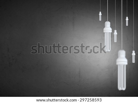 Many light bulbs on color background hanging from above