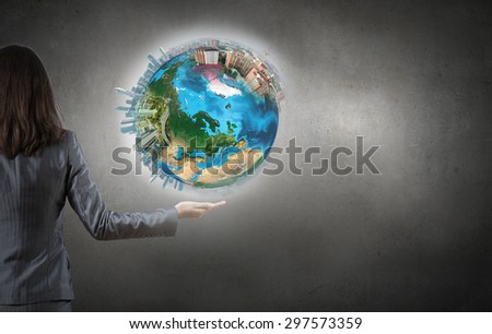 Close up of female hand holding our Earth planet. Elements of this image are furnished by NASA