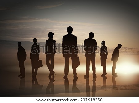 Silhouettes of group of business people standing in line on sunset background