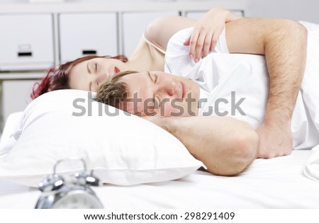 Young couple sleeping peacefully in the bed