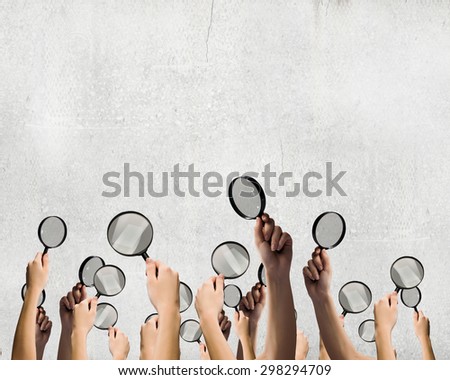 Close p of man\'s hands holding magnifying glass