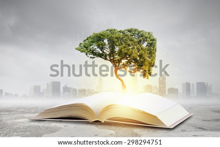 Conceptual image with green tree growing from book
