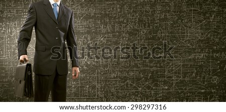 Chest view of businessman and chalk business sketches on wall