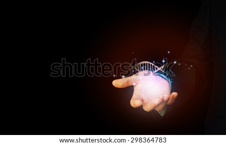 Close up of man holding DNA molecule in palm