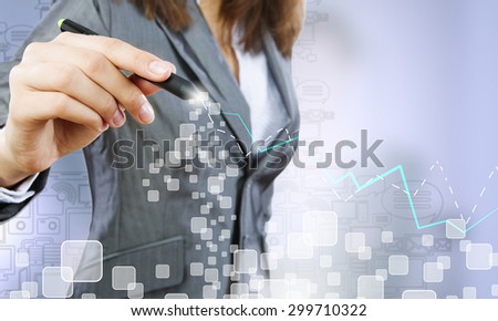 Chest view of businesswoman drawing with pencil increasing graph