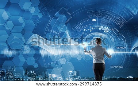 Back view of businesswoman working with modern virtual technologies