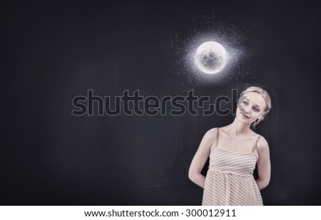 Young pretty smiling woman looking at moon