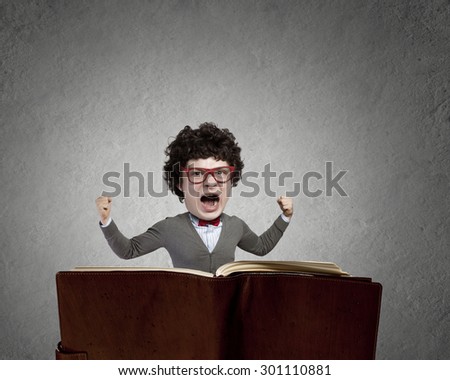 Young man in glasses with opened book in hands