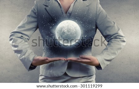 Close up of businesswoman holding in hands full moon