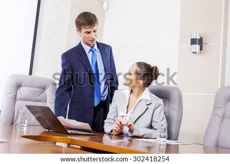 Young businessman showing lady boss business documents