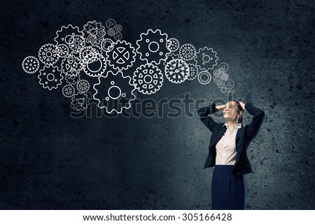 Young businesswoman with hands on head thinking something over