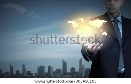Close up of businessman presenting world map in palm