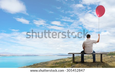 Fat man sitting on bench with his back and looking away
