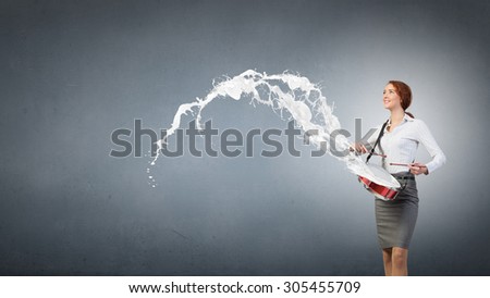 Young businesswoman playing drums and white splashes of paint