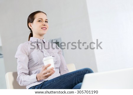 Young pretty girl in casual sitting with coffee in hands
