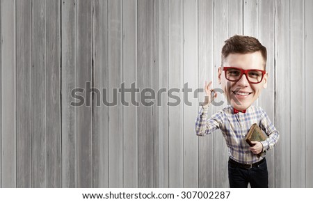 Funny big headed man in glasses with book in hands showing ok gesture
