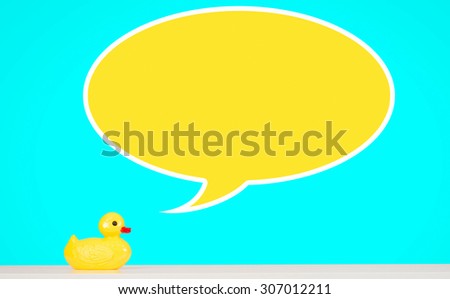 Yellow rubber duck toy on table with speech bubble