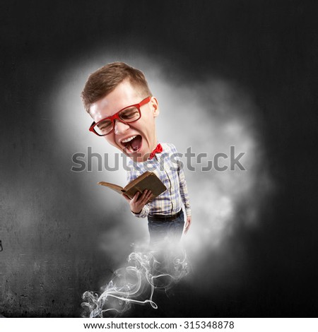Young funny big headed man in glasses with book in hands
