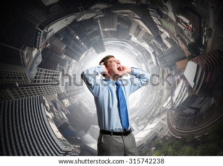 Frustrated businessman screaming and covering his ears with hands