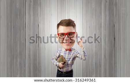 Young funny big headed man in glasses with book in hands showing ok gesture