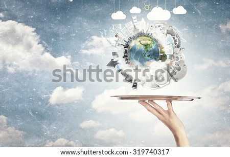Hand holding metal tray with modern cityscape. Elements of this image are furnished by NASA