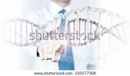 Science concept image of human hand touching DNA molecule
