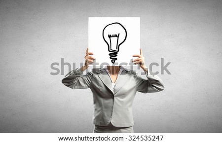 Unrecognizable businesswoman holding paper covering her face