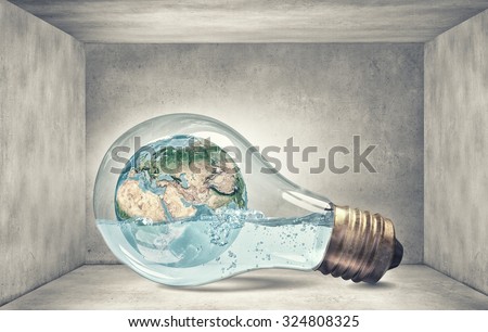 Glass light bulb filled with water and floating Earth planet. Elements of this image are furnished by NASA