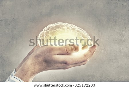 Close up of human hand holding brain