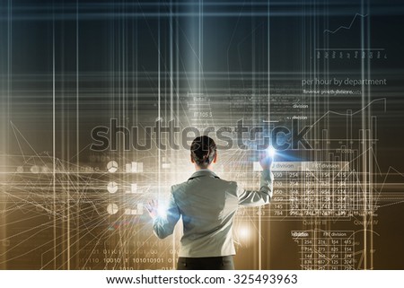Back view of businesswoman working with digital virtual panel