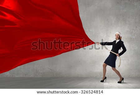 Santa woman in suit pulling red clothing banner