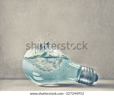 Glass light bulb with water and cityscape inside