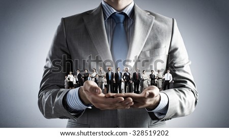 Close up of businessman holding in hands successful people of different professions