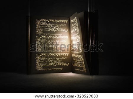 Old black magic book with lights on pages