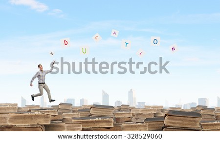 Full length of student running with book in hand