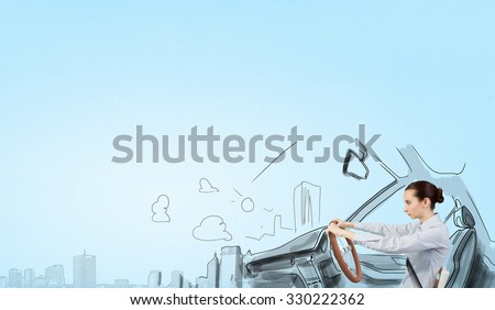 Young smiling pretty woman in drawn car with driving steering wheel