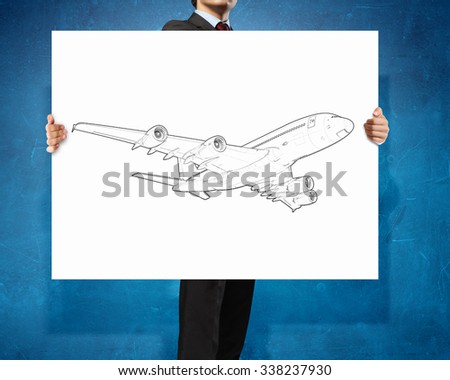 Unrecognizable man showing white banner with airplane design
