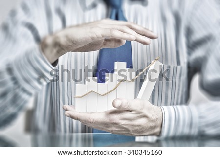 Hands of businessman covering rising growth graph